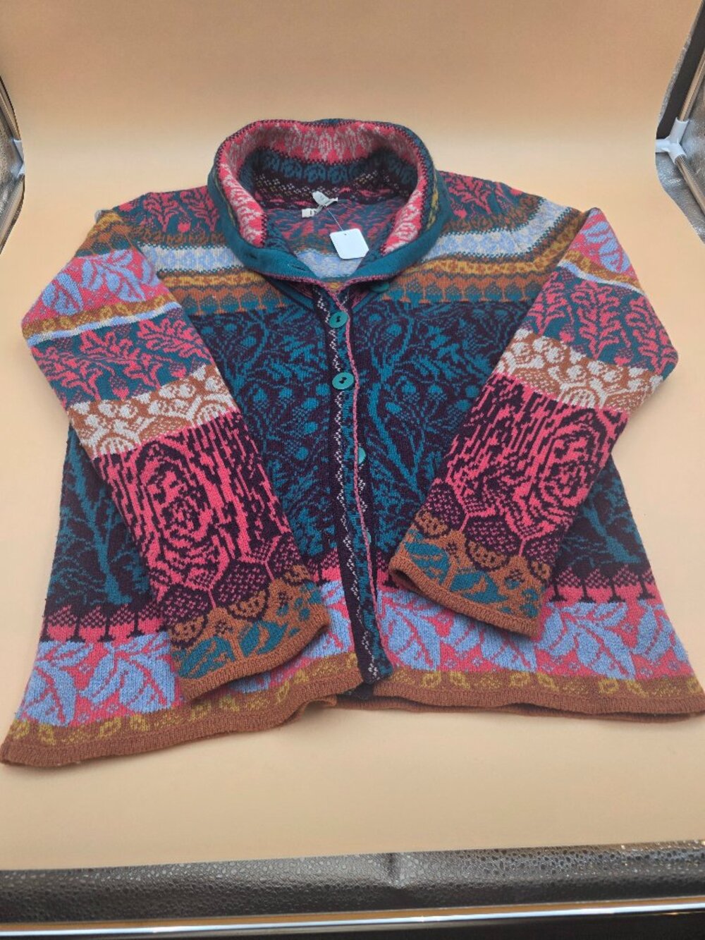 Ivko sweater. Multi-colored with patterns. It buttons up.